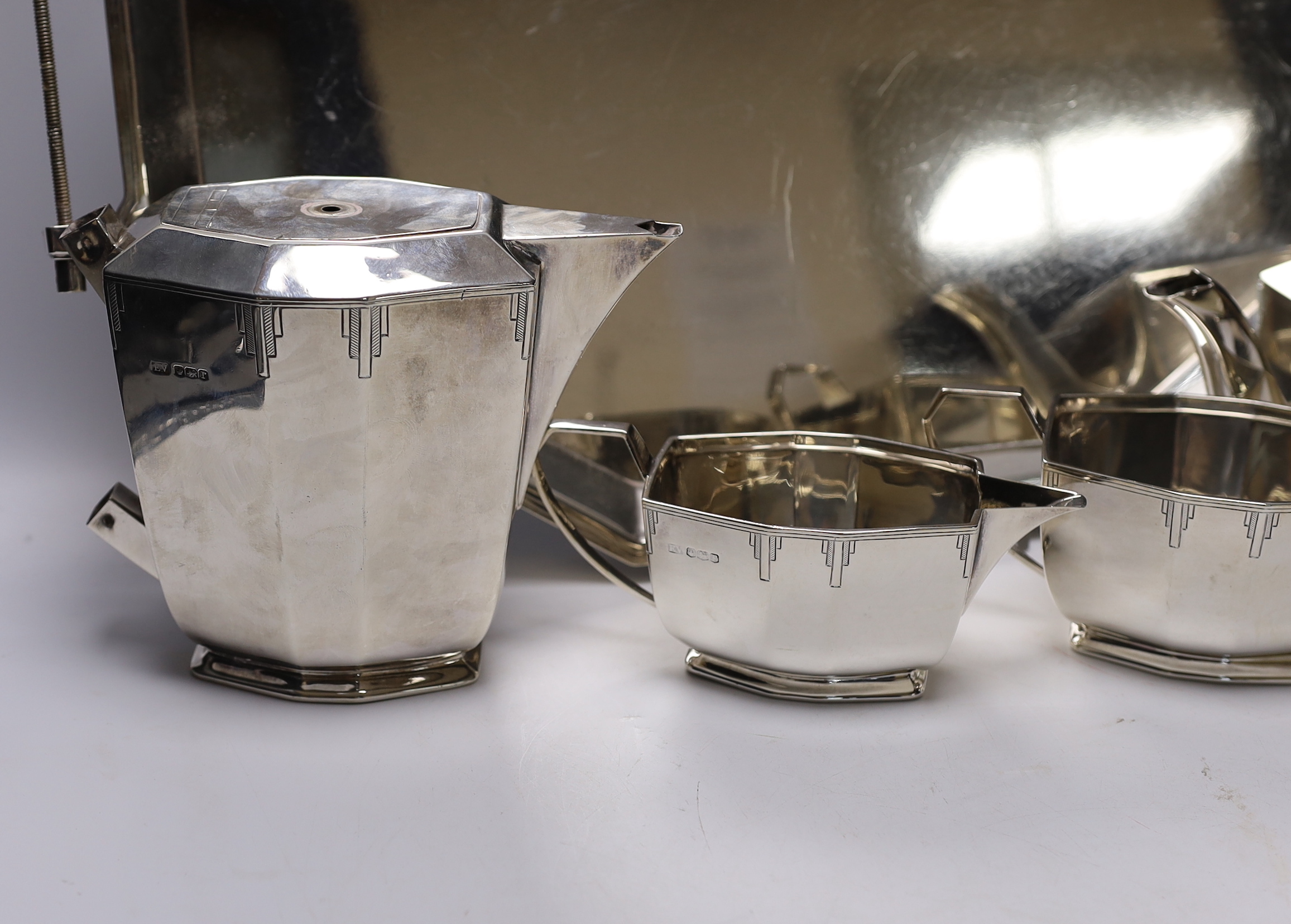 A George V Art Deco silver four piece tea set with tea tray, by Viners Ltd, Sheffield, 1934/36, 114.5oz. (lacking handles)